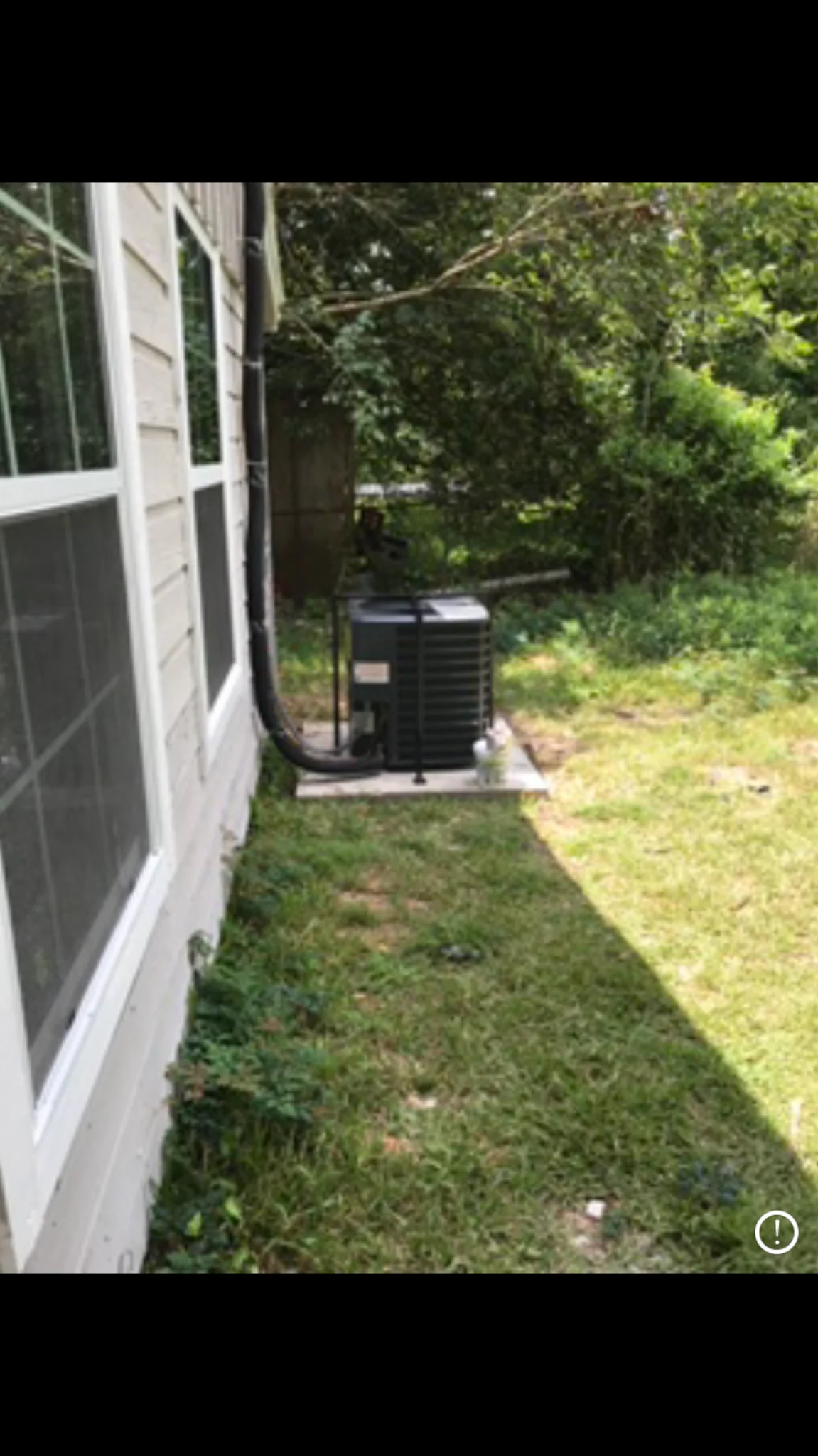 Outdoor air-conditioning condenser protected by a security cage
