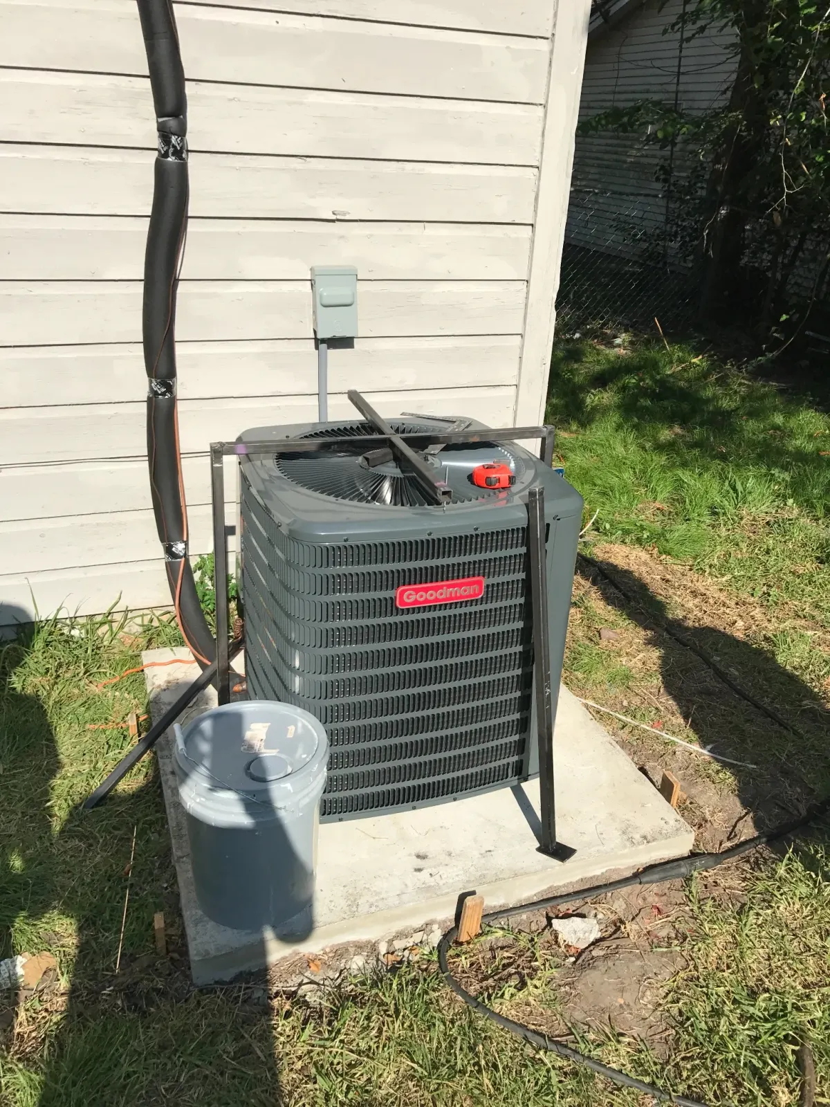 Goodman AC condenser with security cage — Pearland HVAC repair
