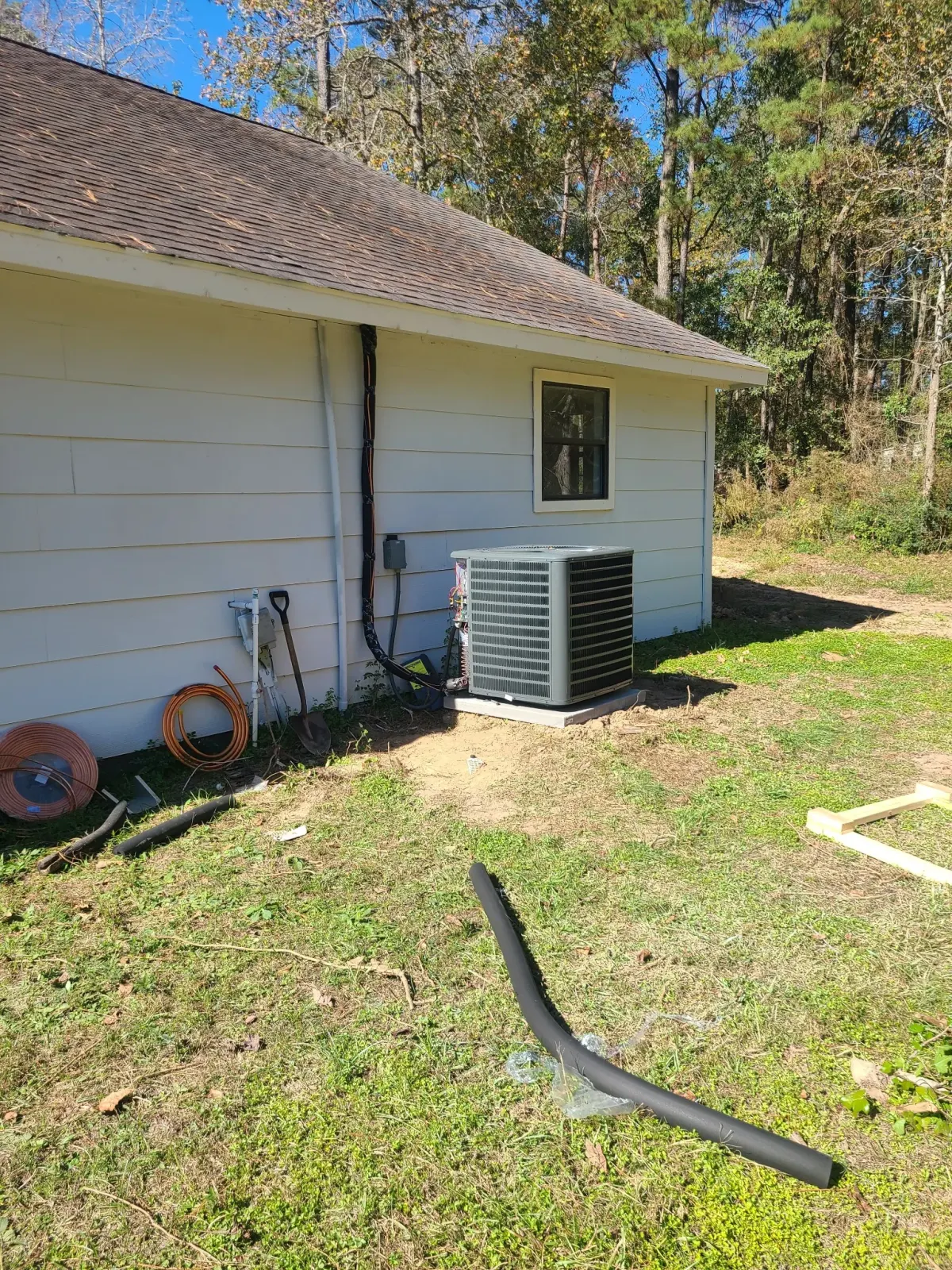 AC condenser installation in residential side yard — HVAC repair Brazoria TX