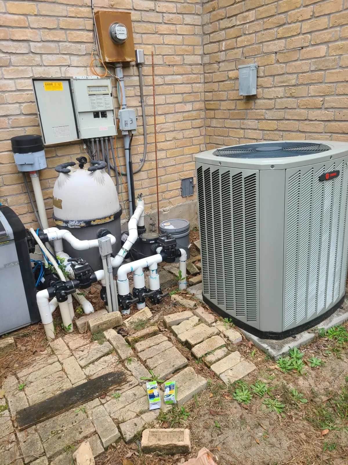 Trane AC condenser near pool equipment — Pearland HVAC repair